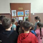 Dziewczęta czytają młodszym kolegom.