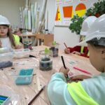 Uczniowie projektują mini ogród w słoiku.